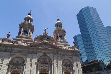 Santiago de Chile, Chile - November 26, 2015: The cathedral at the main square next to a modern building in Santiago de Chile.の写真素材