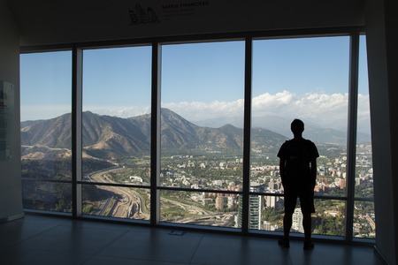 Silhouette of man enjoying view from Gran Torre Santiago in Santiago de Chile.の写真素材