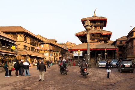 Bhaktapur, Nepal - December 04, 2014: A busy market square with a tmeple in the city centerのeditorial素材