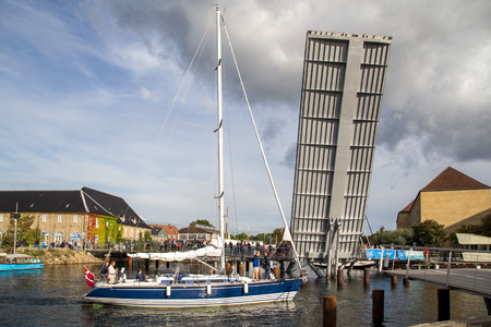 Sailboat passes open drawbridge in Copenhagen, Denmarkのeditorial素材