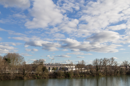 Toulouse, France - February 19, 2016: Photograph of the river Garonne and the soccer stadium.のeditorial素材