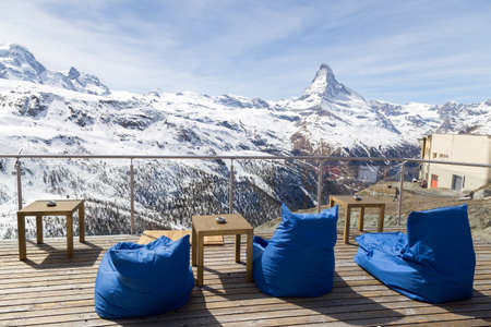 Empty chair cushion in a bar and restaurant in the Matterhorn skiing area. Famous Matterhorn in the background.の写真素材