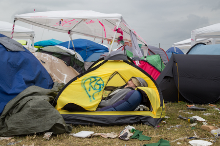 Roskilde, Denmark - July 1, 2016: Young man sleeping in his tent on the camping area at Roskilde Festival 2016のeditorial素材