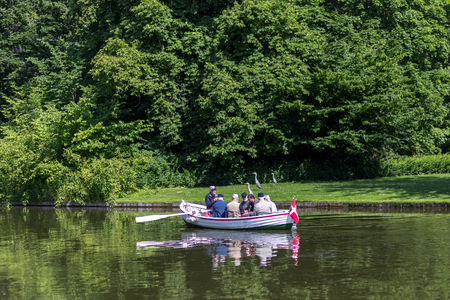 Frederiksberg, Denmark - June 17, 2017: Group of people in a rowboat in Frederiksberg Park. Frederiksberg Gardens is one of the largest and most attractive greenspaces in Copenhagenのeditorial素材