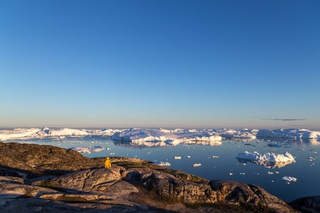 Ilulissat, Greenland - July 7, 2018: View of the Ilulissat Icefjord during midnight sun.の写真素材