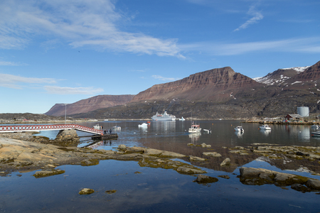 Ilulissat, Greenland - July 06, 2018: A big cruise ship and fishing boats anchored in Qeqertarsuaq harborのeditorial素材