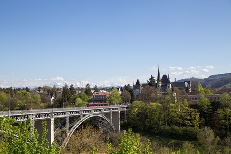 Bern, Switzerland - April 13, 2017: Train driving over Kirchenfeld Bridge in the historic city centre.のeditorial素材