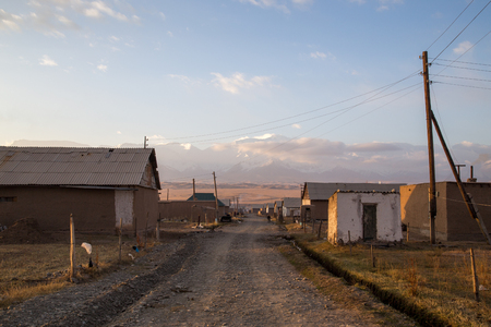 Sary-Mogul, Kyrgyzstan - October 7, 2014: Gravel road and houses in the village Sary-Mogul in South Kyrgyzstan.のeditorial素材