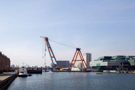 Copenhagen, Denmark - April 4, 2019: The huge Floating Crane Hebo Lift 9 installing parts for a new...