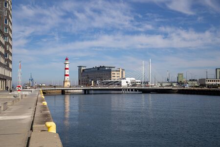 Malmo, Sweden - April 20, 2019: View of historic lighthouse and Univerisy Bridge in the harbour...