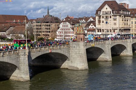 Basel, Switzerland - March 11, 2019: Dressed up people at the traditional carnival parade on Mittlere Bridge.のeditorial素材