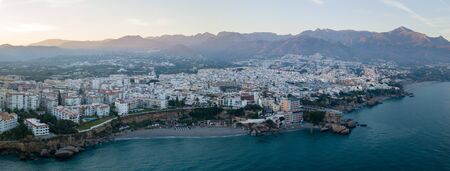 Nerja, Spain - May 28, 2019: Aerial drone view of Nerja and the Mediterranean Sea during sunset.の写真素材