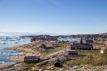 Ilulissat, Greenland - June 30, 2018: View of the city with the church and colorful houses.のeditorial素材