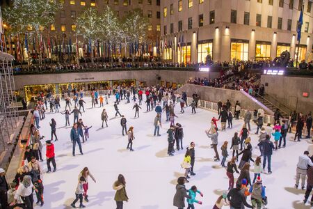New York, United States of America - November 19, 2016: People on the ice skating rink at the famous Rockefeller Centerのeditorial素材