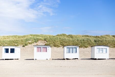 Lokken, Denmark - July 19, 2019: White beach cabins at the sand beach in Lokken in Northern Jutland.の写真素材
