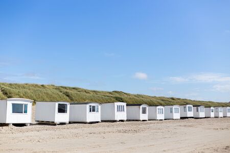 Lokken, Denmark - July 19, 2019: White beach cabins at the sand beach in Lokken in Northern Jutland.の写真素材
