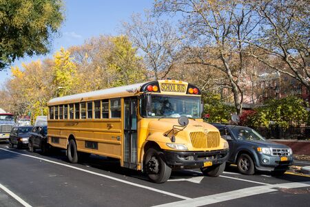 New York, United States of America - November 19, 2016: A yellow school bus in the streets of Manhattan.のeditorial素材