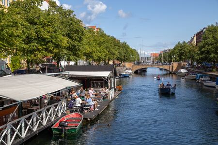 Copenhagen, Denmark - August 21, 2019: A canal and boats in Christianshavn district in the historic...