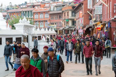 Kathmandu, Nepal - December 3, 2014: Pilgrims and tourists walking around the historic Boudhanath...