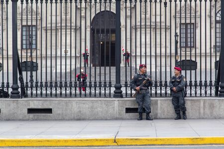 Lima, Peru - September 2, 2015: Soldiers at a fence in front of the Government Palace in the historic city centreのeditorial素材