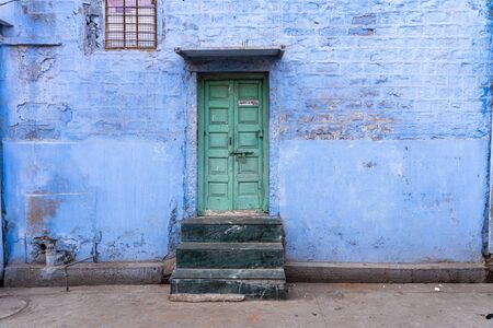 Jodhpur, India - December 9, 2019: An old door to a traditional blue house.のeditorial素材