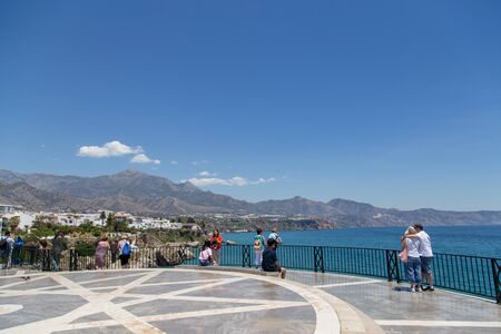 Nerja, Spain - May 28, 2019: People enjoying the view from the viewpoint Balcony of Europe.のeditorial素材