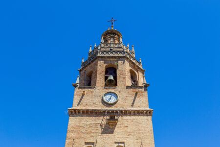 Ronda, Spain - May 31, 2019: The church tower of Iglesia de Santa Maria la Mayor in the historic...