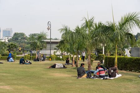 New Delhi, India - December 4, 2019: People on a grass plane in Central Park.のeditorial素材