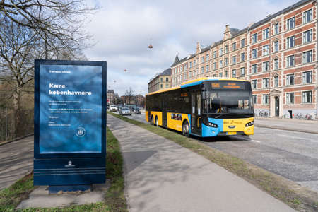 Copenhagen, Denmark - March 20, 2020: Advertisement board next to road displays information about the corona virus.のeditorial素材