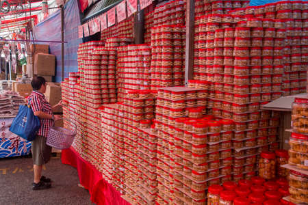 Singapore, Singapore - February 3, 2015: Piles of biscuits and snacks at the local market in Chinatown district.のeditorial素材
