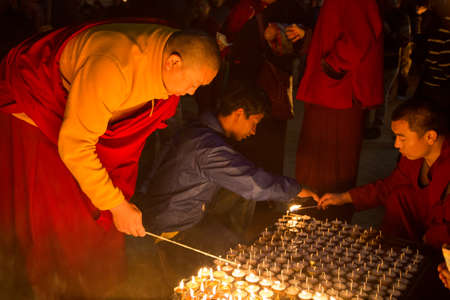 Kathmandu, Nepal - December 06, 2014: Pilgrims at Boudhanath stupa lighting up butter candles for full moon festival.のeditorial素材