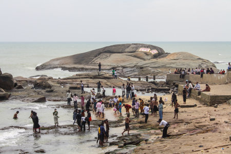 Kanyakumari, India - January 16, 2011: Group of people bathing at the local beachのeditorial素材
