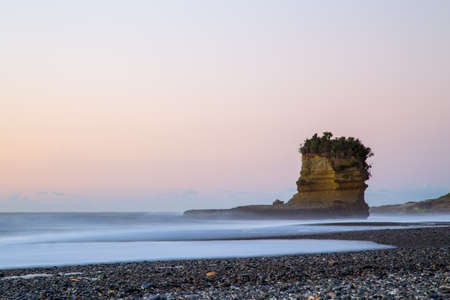 View of Punakaiki beach with special rock formation during sunset time.の写真素材