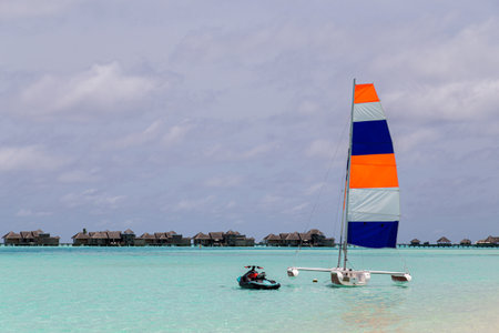Paradise Island, Maldives - August 28, 2018: A catamaran sailing boat with a colorful sailのeditorial素材