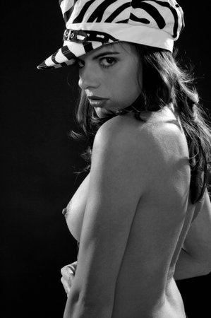 young naked woman with tie and hatの写真素材