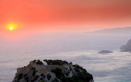 Sunset at Monolithos Venitian Castle on the west coast of Rhodes in Greeceの写真素材