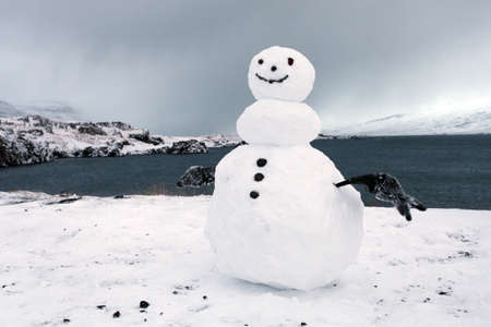 East fjords in Iceland and a winter snowman