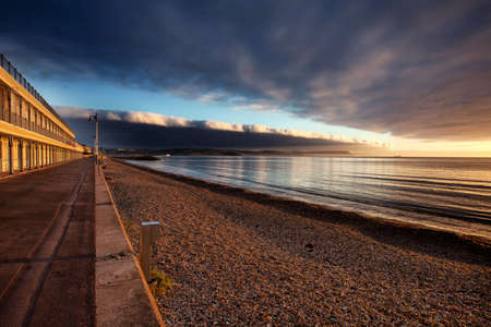 Traditional Seaside Victorian Beach Huts & Cafe Along the Sea Frontの写真素材