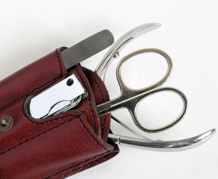 manicure tools: nail scissors, nippers, tongs and a clasp-knife against white backgroundの写真素材
