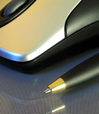 a pen and a computer mouse close-up        の写真素材