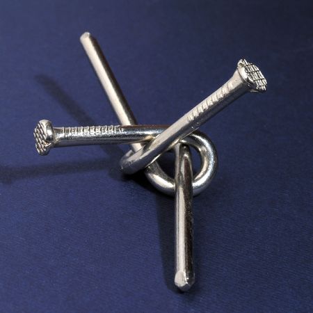 two twisted metal nails - an amusing puzzle         の写真素材