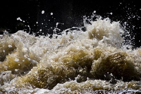 foaming and splashing yellow waves of a river