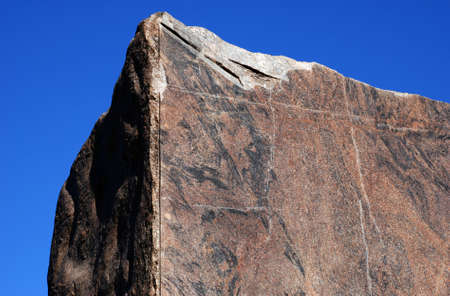 large block of granite against blue skyの写真素材