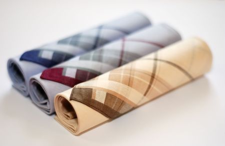 three men`s elegant handkerchiefs against the white background