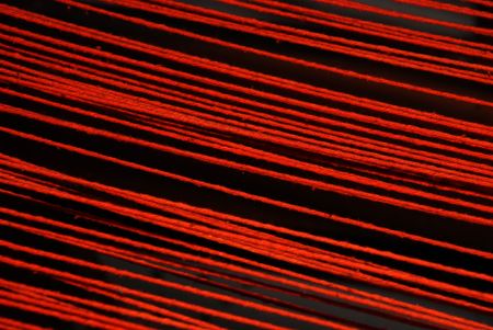 strained thic red threads against black backgroundの写真素材