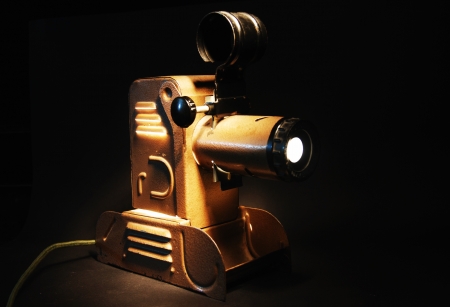 vintage slide projector with the light in dark room