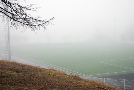 football field in thick fog in the morningの写真素材