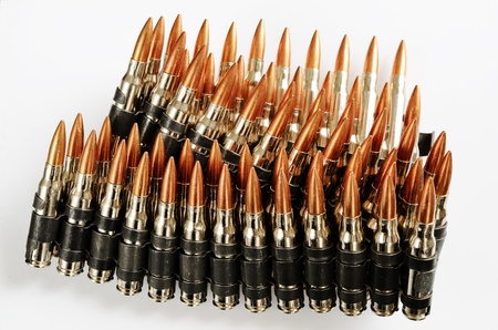 chain of bullets over white, closeup, horizontalの写真素材