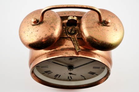 old-fashioned vintage copper alarm clock  over whiteの写真素材