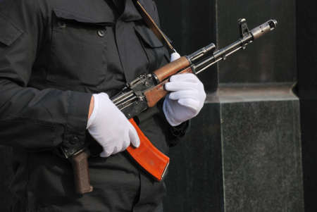 hands in white gloves with an assault rifleのeditorial素材